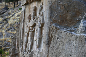 صحنه تاجگذاری اردشیر دوم، نهمین شاه ساسانی، نخستین نقش برجسته‌ی حکاکی شده در طاق بستان است که در کنار طاق کوچک قرار دارد. این سنگ نگاره 1600 ساله، اردشیر دوم را در حال گرفتن حلقه‌ای از اهورامزدا با دست راست نشان می‌دهد که دست چپ او به نشانه عدالت و جنگاوری به شمشیرش تکیه داده شده‌ است.در زیر پای اردشیر دوم و اهورا مزدا پیکر یولیانوس امپراطور روم قرار دارد که به ایران حمله کرد‌ه و شکست خورده بود. برخی از نقوش در این سنگ‌نگاره مخدوش شده‌اند. که علت آن‌ها نیز مشخص نیست.