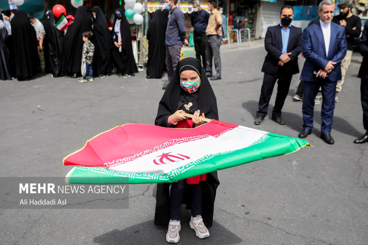 دختر بچه خردسالی با برافراشتن پرچم کشورمان در مراسم راهپیمایی روز جهانی قدس در تهران حضور دارد